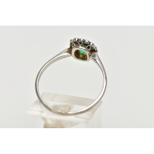 54 - A WHITE METAL, EMERALD AND DIAMOND CLUSTER RING, centering on an emerald cut emerald, in a milgrain ... 