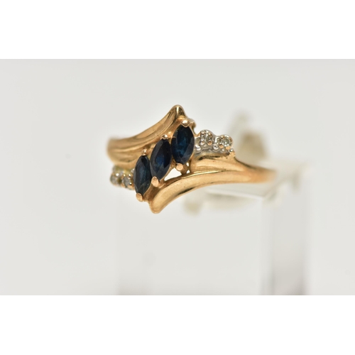 13 - A YELLOW METAL GEMSET DRESS RING, three marquise cut sapphires accented with four single cut diamond... 