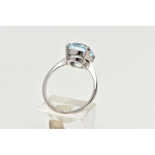 2 - A MODERN 18CT GOLD TOPAZ RING, an oval cut light blue topaz, approximate dimensions length 12mm x wi... 