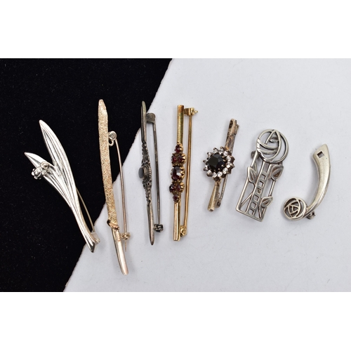 32 - SEVEN BROOCHES, to include a silver openwork floral brooch, hallmarked Edinburgh, a gold plated bohe... 