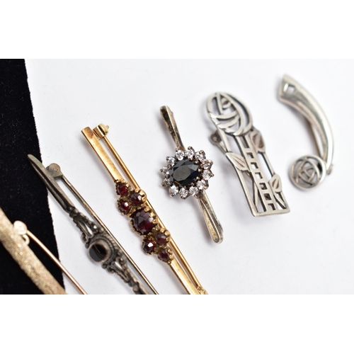 32 - SEVEN BROOCHES, to include a silver openwork floral brooch, hallmarked Edinburgh, a gold plated bohe... 