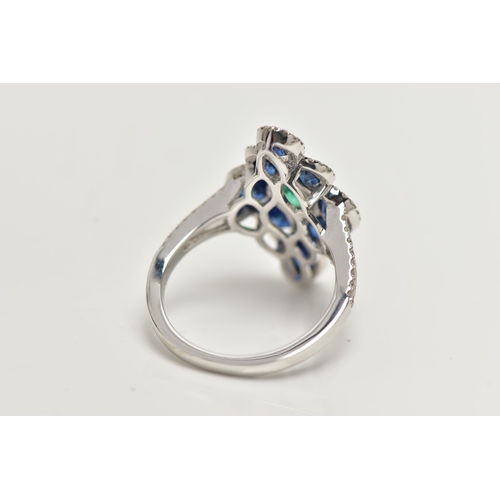 35 - AN 18CT WHITE GOLD GEM SET DRESS RING, of a marquise outline, set to the centre is an oval cut emera... 