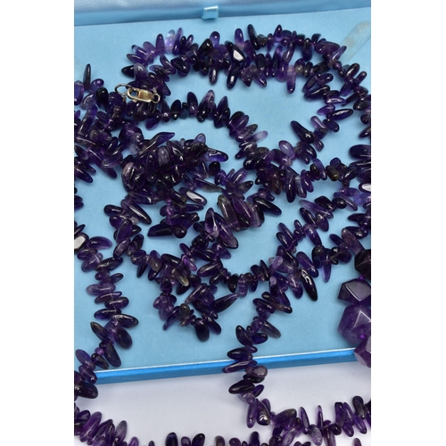 76 - TWO LARGE STATEMENT AMETHYST BEAD NECKLACES, the first a double row of irregular amethyst beads, fit... 