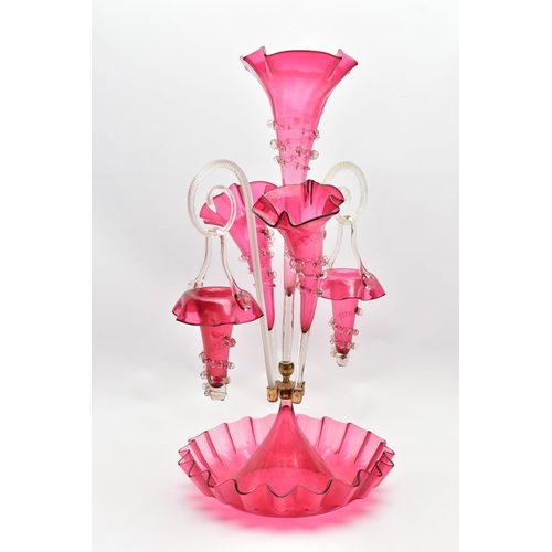 114 - A VICTORIAN CRANBERRY AND CLEAR GLASS EPERGNE, the central trumpet with trailing decoration, enclose... 