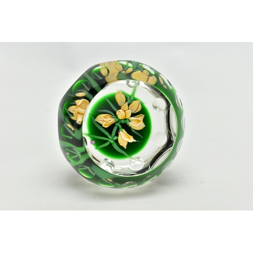 118 - A PERTHSHIRE GLASS PAPERWEIGHT, containing pale yellow buds and flowers on green stalks and 'P' in a... 