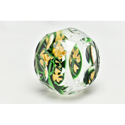 118 - A PERTHSHIRE GLASS PAPERWEIGHT, containing pale yellow buds and flowers on green stalks and 'P' in a... 