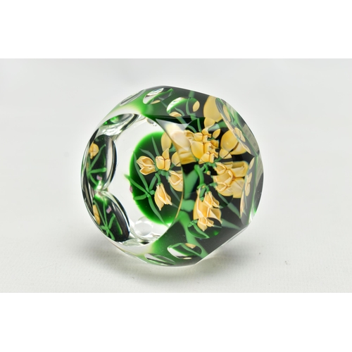 118 - A PERTHSHIRE GLASS PAPERWEIGHT, containing pale yellow buds and flowers on green stalks and 'P' in a... 