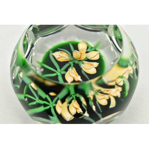 118 - A PERTHSHIRE GLASS PAPERWEIGHT, containing pale yellow buds and flowers on green stalks and 'P' in a... 