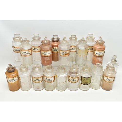 122 - A COLLECTION OF TWENTY CLEAR GLASS PHARMACY BOTTLES OF CYLINDRICAL FORM WITH STOPPERS, one is of a d... 