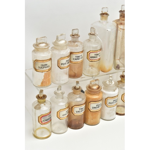 123 - A COLLECTION OF TWENTY ONE CLEAR GLASS PHARMACY BOTTLES WITH STOPPERS, three of rectangular form, ap... 