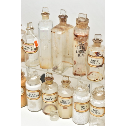 123 - A COLLECTION OF TWENTY ONE CLEAR GLASS PHARMACY BOTTLES WITH STOPPERS, three of rectangular form, ap... 