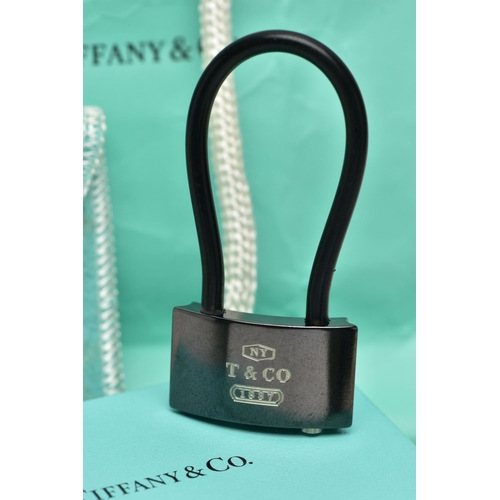 10 - A CASED TIFFANY & CO. PADLOCK, the black titanium padlock, with black rubber loop, signed 'NY T& Co.... 