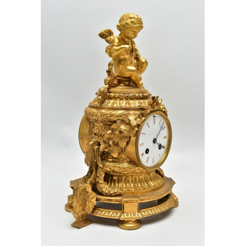 161 - A LATE 19TH CENTURY FRENCH ORMOLU MANTEL CLOCK OF SHAPED CYLINDRICAL FORM, the circular top with sea... 