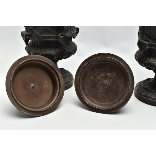 181 - A PAIR OF 19TH CENTURY BLACK PAINTED SPELTER TWIN HANDLED URNS AND COVERS, the covers cast with a pu... 