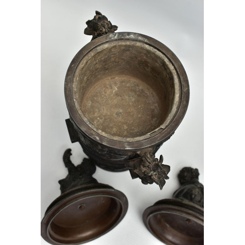 181 - A PAIR OF 19TH CENTURY BLACK PAINTED SPELTER TWIN HANDLED URNS AND COVERS, the covers cast with a pu... 