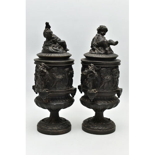 181 - A PAIR OF 19TH CENTURY BLACK PAINTED SPELTER TWIN HANDLED URNS AND COVERS, the covers cast with a pu... 