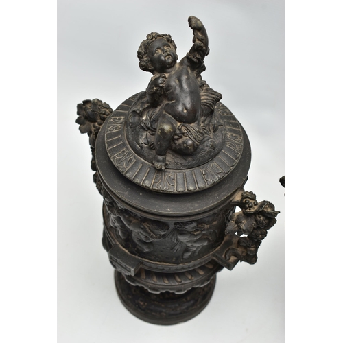 181 - A PAIR OF 19TH CENTURY BLACK PAINTED SPELTER TWIN HANDLED URNS AND COVERS, the covers cast with a pu... 