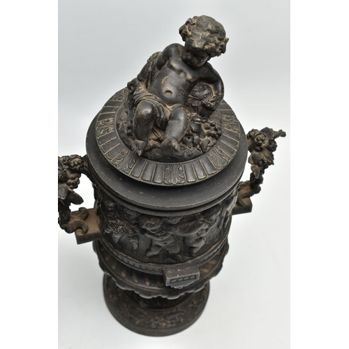 181 - A PAIR OF 19TH CENTURY BLACK PAINTED SPELTER TWIN HANDLED URNS AND COVERS, the covers cast with a pu... 