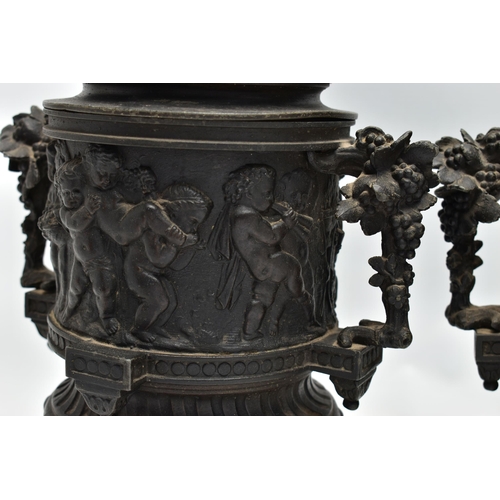 181 - A PAIR OF 19TH CENTURY BLACK PAINTED SPELTER TWIN HANDLED URNS AND COVERS, the covers cast with a pu... 