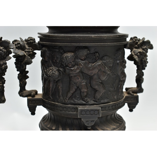 181 - A PAIR OF 19TH CENTURY BLACK PAINTED SPELTER TWIN HANDLED URNS AND COVERS, the covers cast with a pu... 