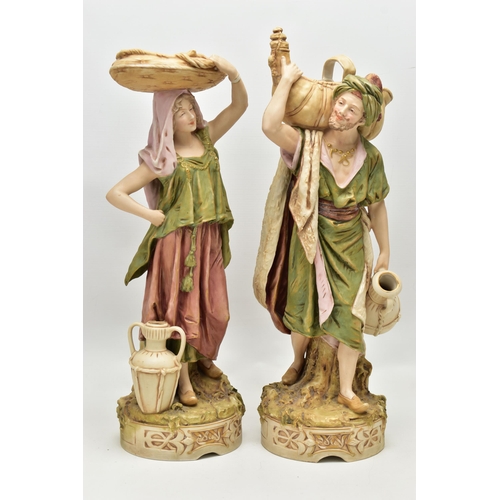 195 - A PAIR OF ROYAL DUX FIGURES OF MALE AND FEMALE WATER CARRIERS, modelled as standing on circular base... 