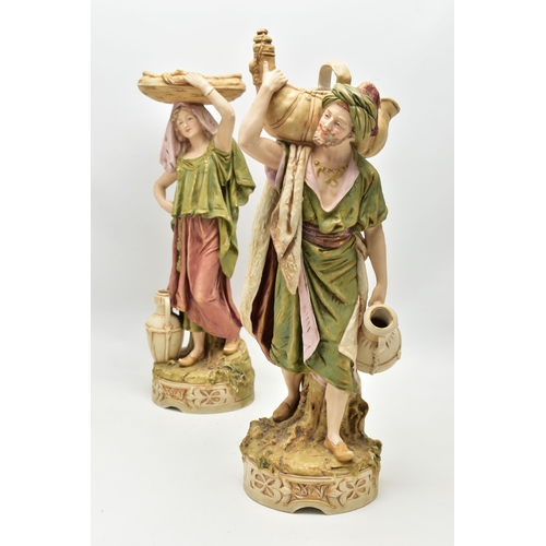 195 - A PAIR OF ROYAL DUX FIGURES OF MALE AND FEMALE WATER CARRIERS, modelled as standing on circular base... 