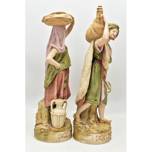 195 - A PAIR OF ROYAL DUX FIGURES OF MALE AND FEMALE WATER CARRIERS, modelled as standing on circular base... 