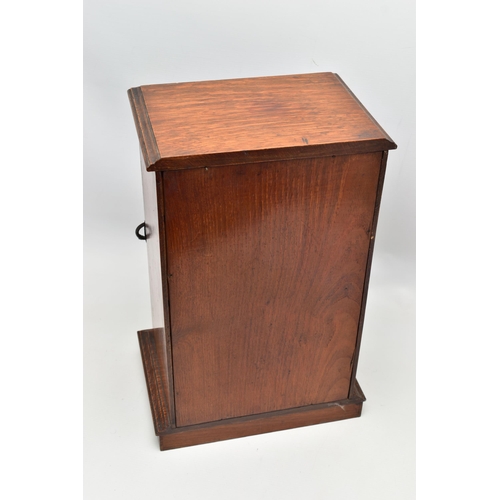 208 - A LATE VICTORIAN OAK CASED SMOKERS CABINET, the bevel edged glazed door opening to reveal a pipe rac... 