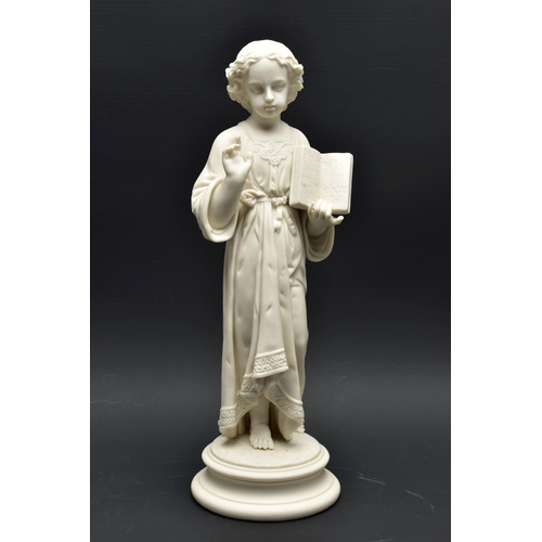 132 - A 19TH CENTURY PARIAN FIGURE OF THE CHRIST CHILD, modelled wearing robes, holding an open book inscr... 