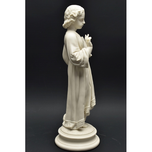 132 - A 19TH CENTURY PARIAN FIGURE OF THE CHRIST CHILD, modelled wearing robes, holding an open book inscr... 