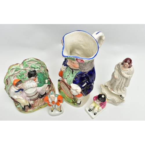 215 - A VICTORIAN STAFFORDSHIRE POTTERY TOBY JUG AND FOUR VICTORIAN STAFFORDSHIRE FIGURES, comprising a ju... 