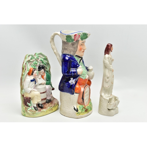 215 - A VICTORIAN STAFFORDSHIRE POTTERY TOBY JUG AND FOUR VICTORIAN STAFFORDSHIRE FIGURES, comprising a ju... 