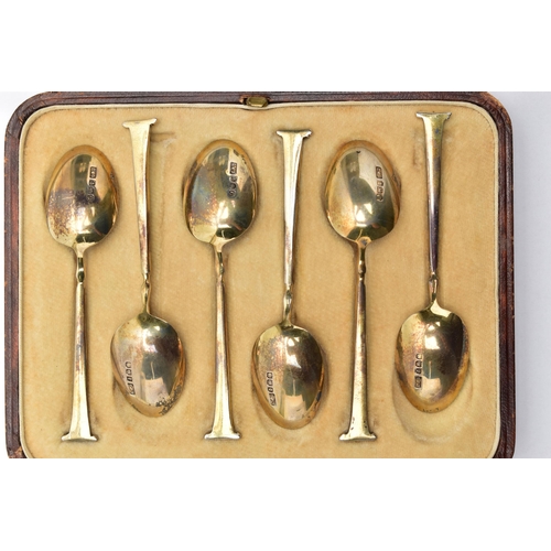 58 - A CASED SET OF SIX GEORGE V SILVER GILT AND ENAMEL COFFEE SPOONS, the handles engine turned and enam... 