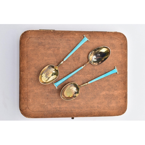 58 - A CASED SET OF SIX GEORGE V SILVER GILT AND ENAMEL COFFEE SPOONS, the handles engine turned and enam... 