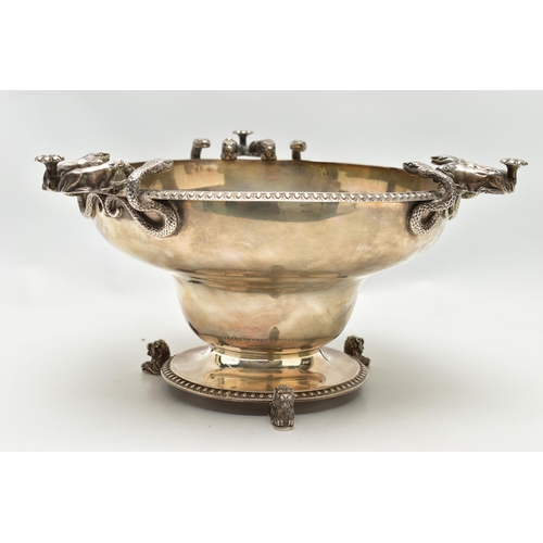 65 - A GEORGE V SILVER PEDESTAL BOWL, with three cast handles, each formed of two serpents and two lion d... 