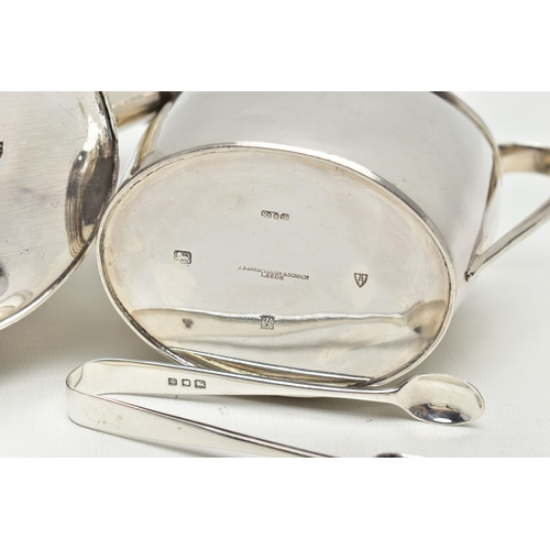 70 - A GEORGE V SILVER TWO PIECE TEA SET OF OVAL FORM, comprising teapot and sugar bowl with reeded rims,... 