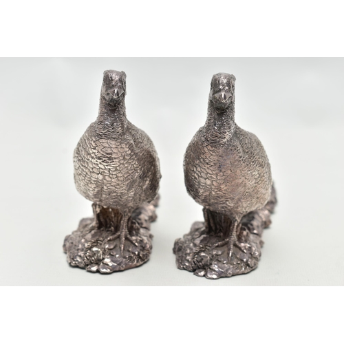 78 - A PAIR OF ELIZABETH II FILLED SILVER TABLE ORNAMENTS IN THE FORM OF COCK PHEASANTS STANDING ON A NAT... 