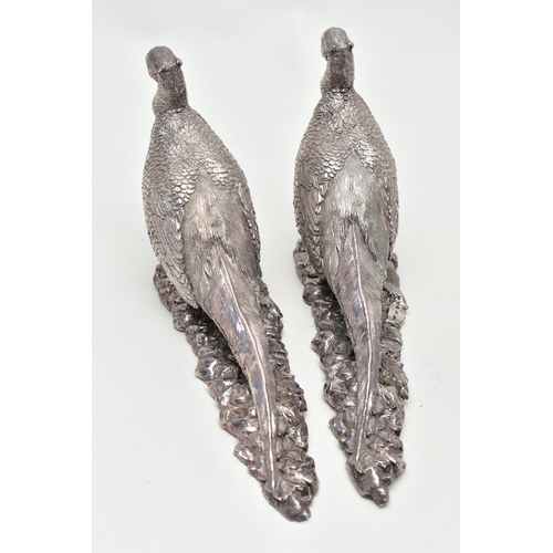 78 - A PAIR OF ELIZABETH II FILLED SILVER TABLE ORNAMENTS IN THE FORM OF COCK PHEASANTS STANDING ON A NAT... 