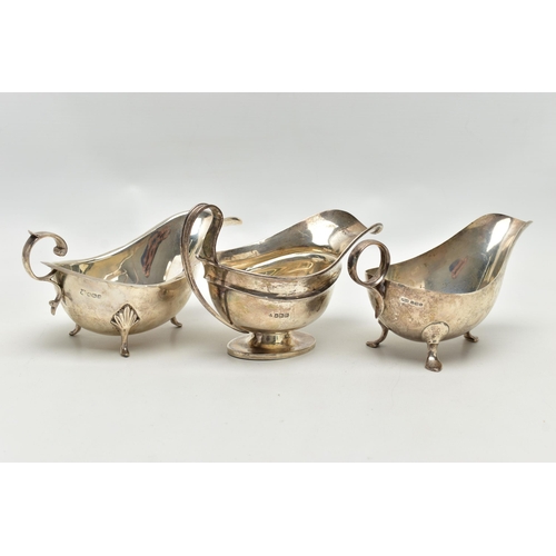 82 - THREE 20TH CENTURY OVAL SILVER SAUCE BOATS OF VARYING DESIGNS, one on an oval foot, stamped 987L to ... 