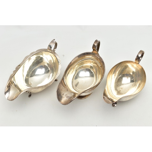 82 - THREE 20TH CENTURY OVAL SILVER SAUCE BOATS OF VARYING DESIGNS, one on an oval foot, stamped 987L to ... 