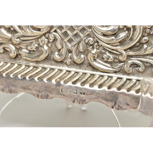 86 - AN EDWARDIAN SILVER TRAY, rectangular form, scalloped edges, embossed with scrolling foliage and flo... 