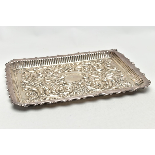 86 - AN EDWARDIAN SILVER TRAY, rectangular form, scalloped edges, embossed with scrolling foliage and flo... 