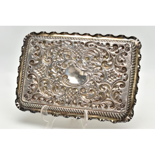 86 - AN EDWARDIAN SILVER TRAY, rectangular form, scalloped edges, embossed with scrolling foliage and flo... 