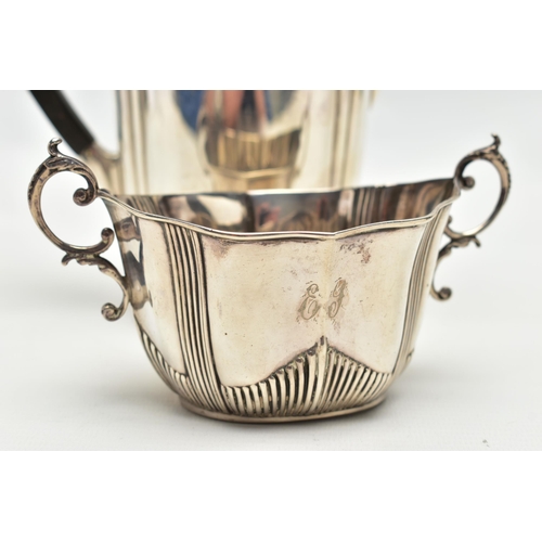 96 - A GEORGE V SILVER HOT WATER JUG AND A LATE VICTORIAN TWIN HANDLED SUGAR BOWL, the hot water jug of s... 