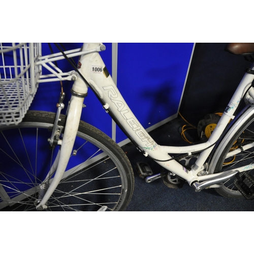 A LADIES RALEIGH CAPRICE BICYCLE with metal front basket along