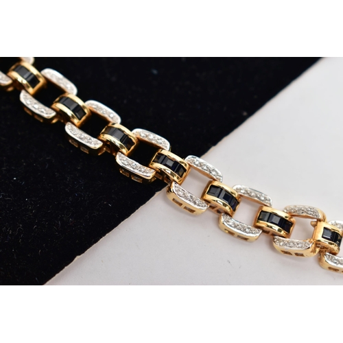 14 - AN 18CT YELLOW GOLD, SAPPHIRE AND DIAMOND LINE BRACELET, designed with a series of openwork square l... 