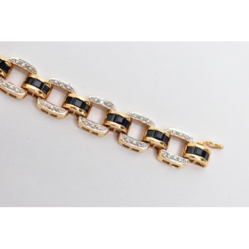 14 - AN 18CT YELLOW GOLD, SAPPHIRE AND DIAMOND LINE BRACELET, designed with a series of openwork square l... 