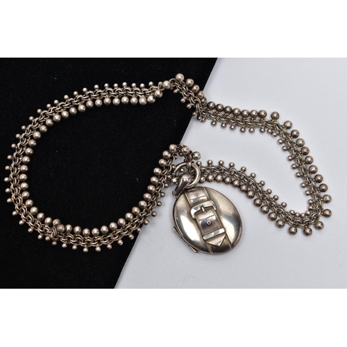 28 - A LATE 19TH CENTURY LOCKET AND CHAIN, oval form silver locket detailed with a belt and buckle design... 