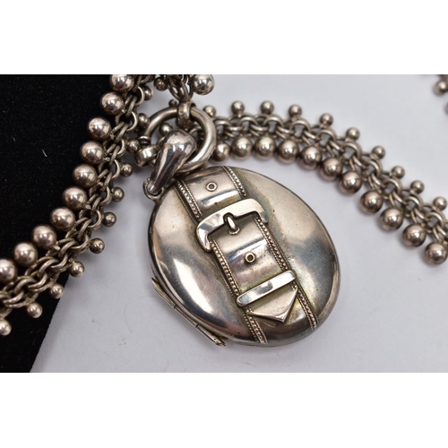 28 - A LATE 19TH CENTURY LOCKET AND CHAIN, oval form silver locket detailed with a belt and buckle design... 