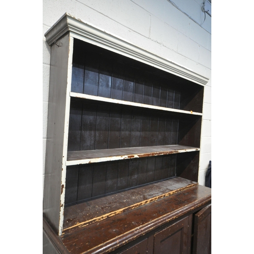 1211 - A 19TH CENTURY PAINTED PINE BOOKCASE, the open shelving top, above a base with triple panelled cupbo... 